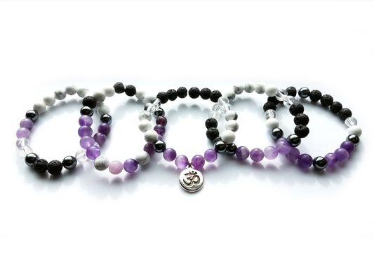 Grouping of the amethyst collection of bracelets with lava stones (can scent with essential oils), and balancing beads.