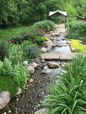 self contained stream and waterfall and plantings.