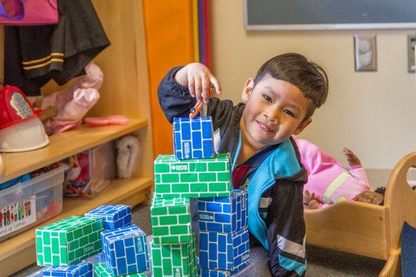 Child building with bricks in children's center.