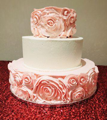 Pretty pink 3 tier flowered cake. Delicious and moist tasting.