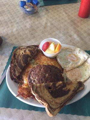 Two eggs sausage patties and eye toast