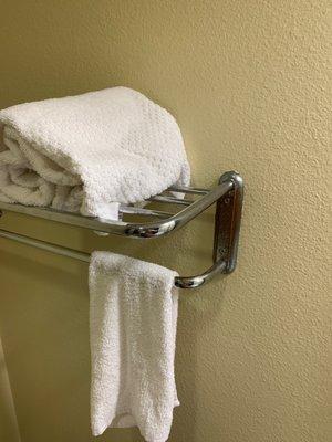 One towel on a rusted towel holder.