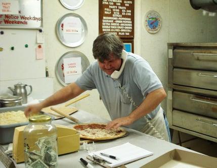 As the sole pizza maker, Joe sometimes has to multitask