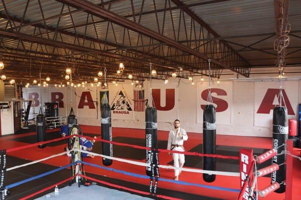 Punching bags and boxing ring.