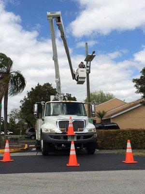 Solcar Electric technician working on light pole fixture