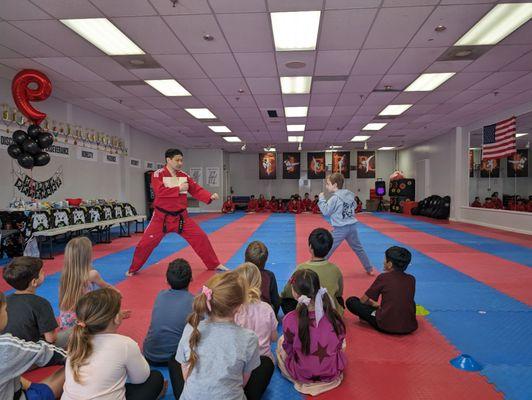 Master Y Kim and my son demonstrating taekwondo skills during his birthday party at Master Chang's Martial Arts