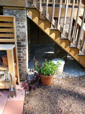 Drainage rock installation under porch.