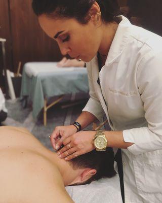 Tara Greenberg, L.Ac. providing acupuncture and cupping on Los Angeles conference attendees in a community style setting.