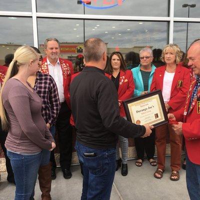 Ribbon cutting with the red coats.