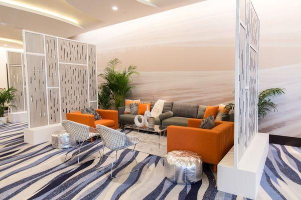 Hues of Grey & Pops of Orange create lounges perfect to network, collaborate, & brainstorm.