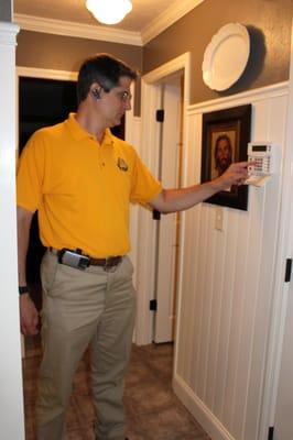 One of our staff members programming a security system.