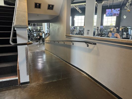 From lobby check in desk, ramp down or stairs up to cardio and weight exercise equipment