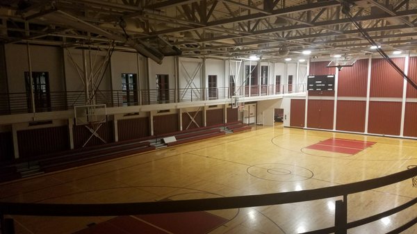 The gym was about to close for the night. That's why half of the court was dimmed.