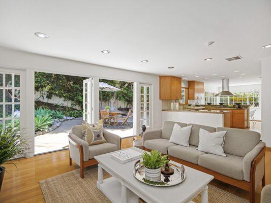 Open floor plan with french doors leading to lush greenery outside in custom home area of Sunny Hills Estates in Fullerton