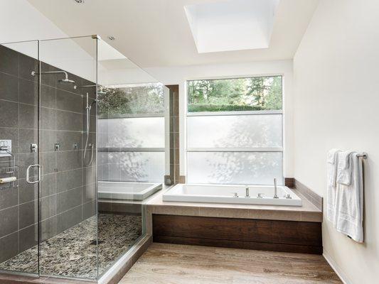 Custom glass shower, tile, sink, window treatments, custom tub and paint. Beautiful modern bathroom.