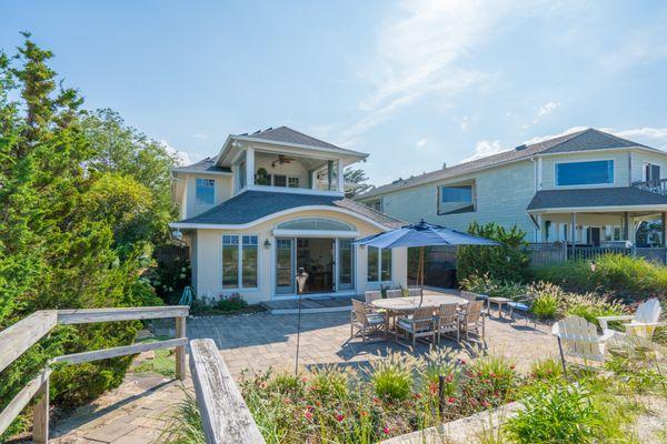 Beach front property beautiful custom-built unique house. Outside / backyard dining area.