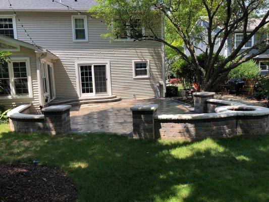 Patio with fire pit on the wall and steps