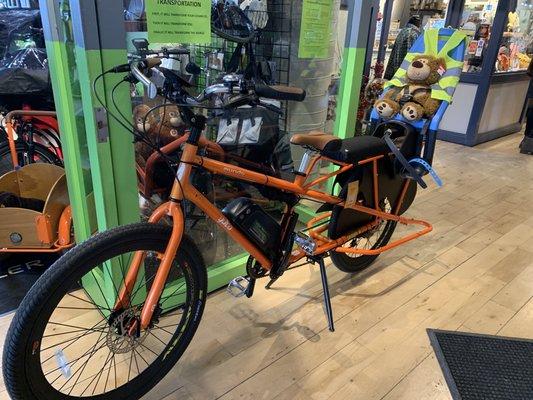 Cargo bikes, each with a demo stuffed animal.