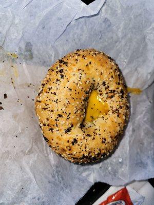 An everything bagel with a sausage, egg, and cheese.