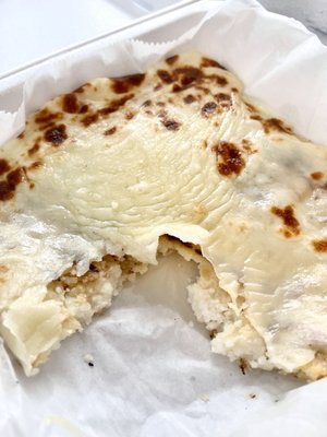 Arepa Con Queso - corn cake with cheese appetizer, after a bite, like a white corn cake with melty cheese on top!