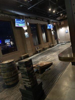 One game area with jenga and corn hole.