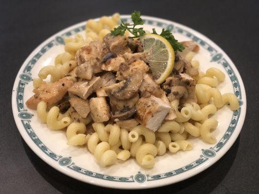 Chicken Marsala garnish with parsley and lemon