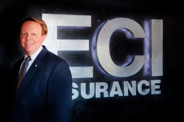 Scott Cornelius with the ECI Insurance sign.