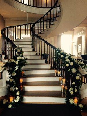 A Sweeping, garland draped staircase!