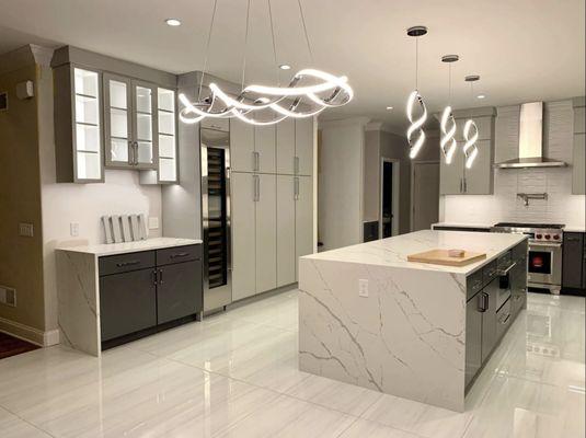 modern lighting and cabinetry in contrast to classical marble counters