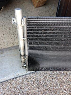 JMAC found a leaking condenser that was struck by debris from road.