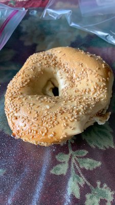 Sad, deflated looking sesame bagel