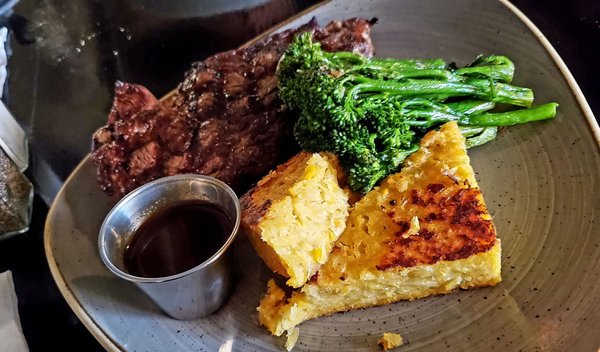 Ribeye, corn cake, brocolinni, and house made steak sauce