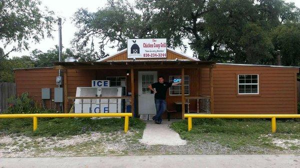 Owner in front of the Chicken Coop Grill