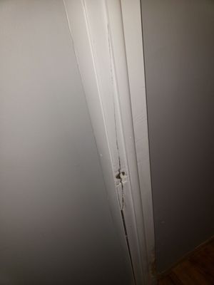 Broken/ split door frame. Never replaced but painted over