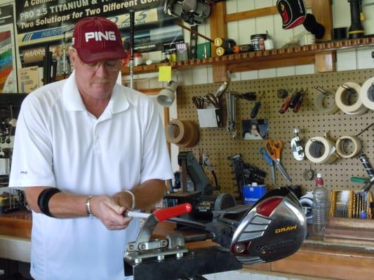 Dave re-gripping clubs in the shop