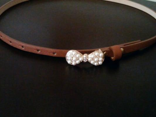 Slim belt with pearlescent bow. $7. Seems to fit for people size 1 - 5 in pants. (I'm size 3 and I'm in the middle buckle)