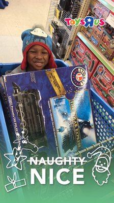 Logan Dunn at Toys R US getting his Polar Express Train!