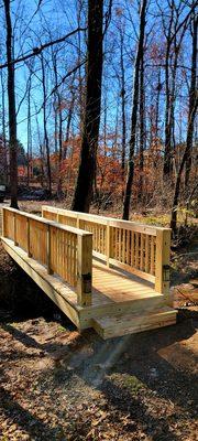 New backyard bridge path to a hot tub oasis.