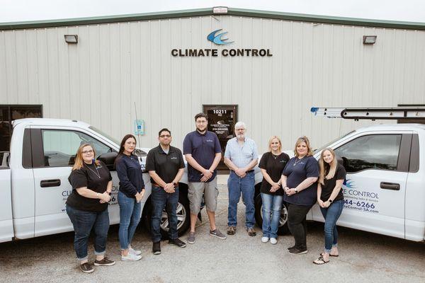 Climate control employees standing outside of office