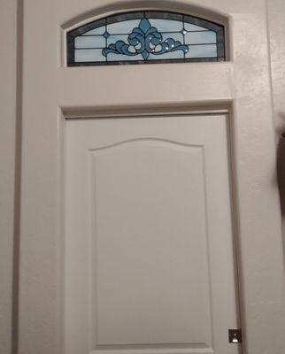 The stained glass insert over pocket door