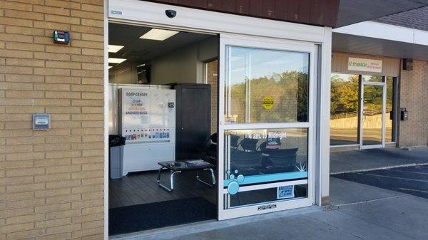 Large automatic door located in parking lot.