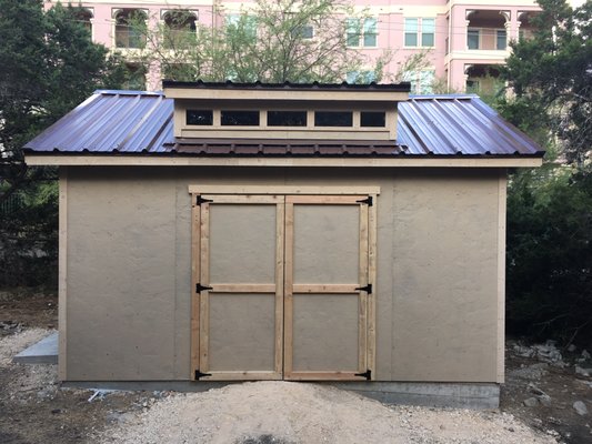 12 by 16 using LP Smartside Stucco style siding on a slab with two 6 foot doors.  8 foot dormer.