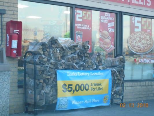 they sell firewood, located just left of the entrance.