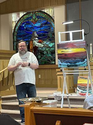 Rev. Dr. Todd Bardin painting during the sermon