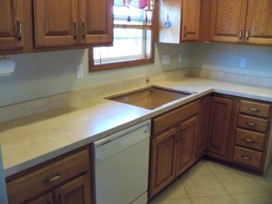 Outdate kitchen counter tops with a straight edge, 4" back splash and plan white walls