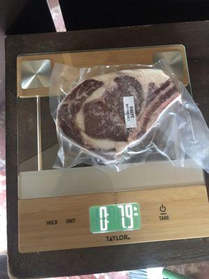 Actual packaging and weight of a cut of meat. The 0 is pounds and the right side number is ounces. A pound is 16 ounces.