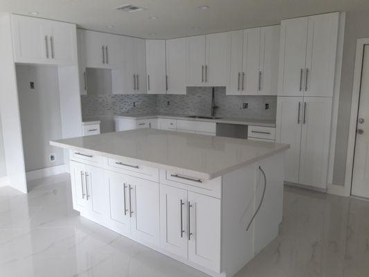 Weston Kitchen Remodeling all white shake doors and Pure White Quartz Countertop with White Glass Tile