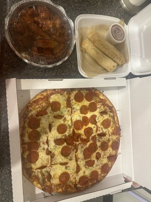 The whole meal: pepperoni and green pepper, Cheese-Stuffed Breadsticks, bourbon wings