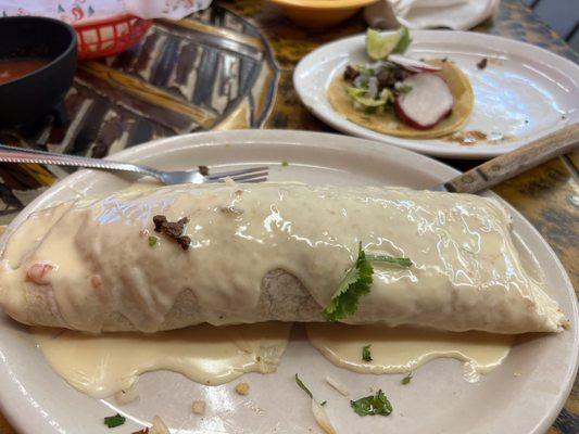 Big burrito with fajita chicken and rice and beans with beef street tacos on the side.