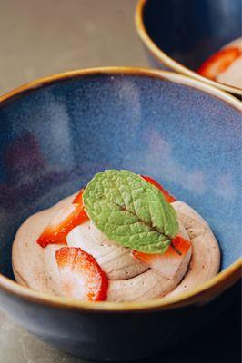 Toasted rice pudding with dark chocolate mousse with strawberries and mint.